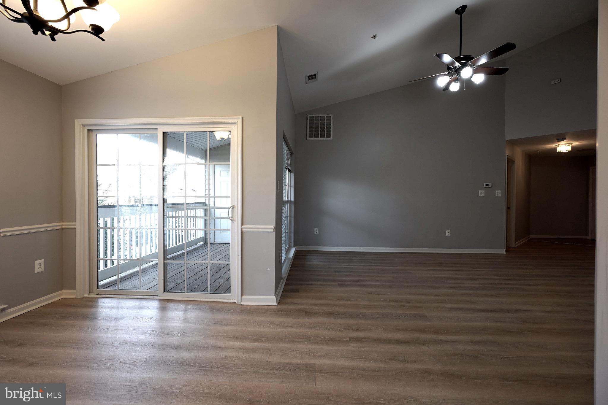 2502 Hemingway Drive, Unit 23B Frederick, MD 21702 - Photo 12 of 30 a view of an empty room with wooden floor and a window