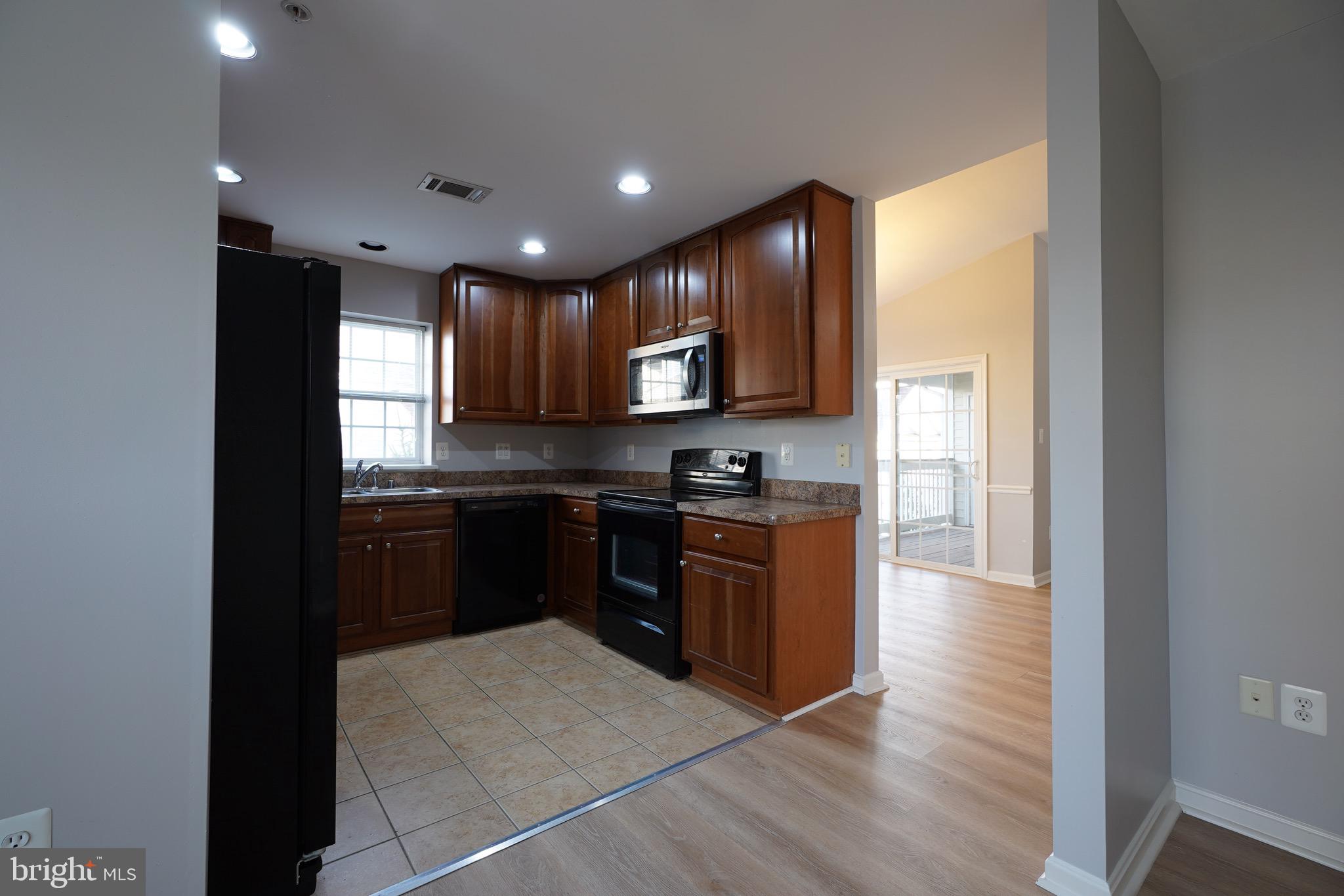 2502 Hemingway Drive, Unit 23B Frederick, MD 21702 - Photo 13 of 30 a kitchen with stainless steel appliances granite countertop a refrigerator and a stove top oven