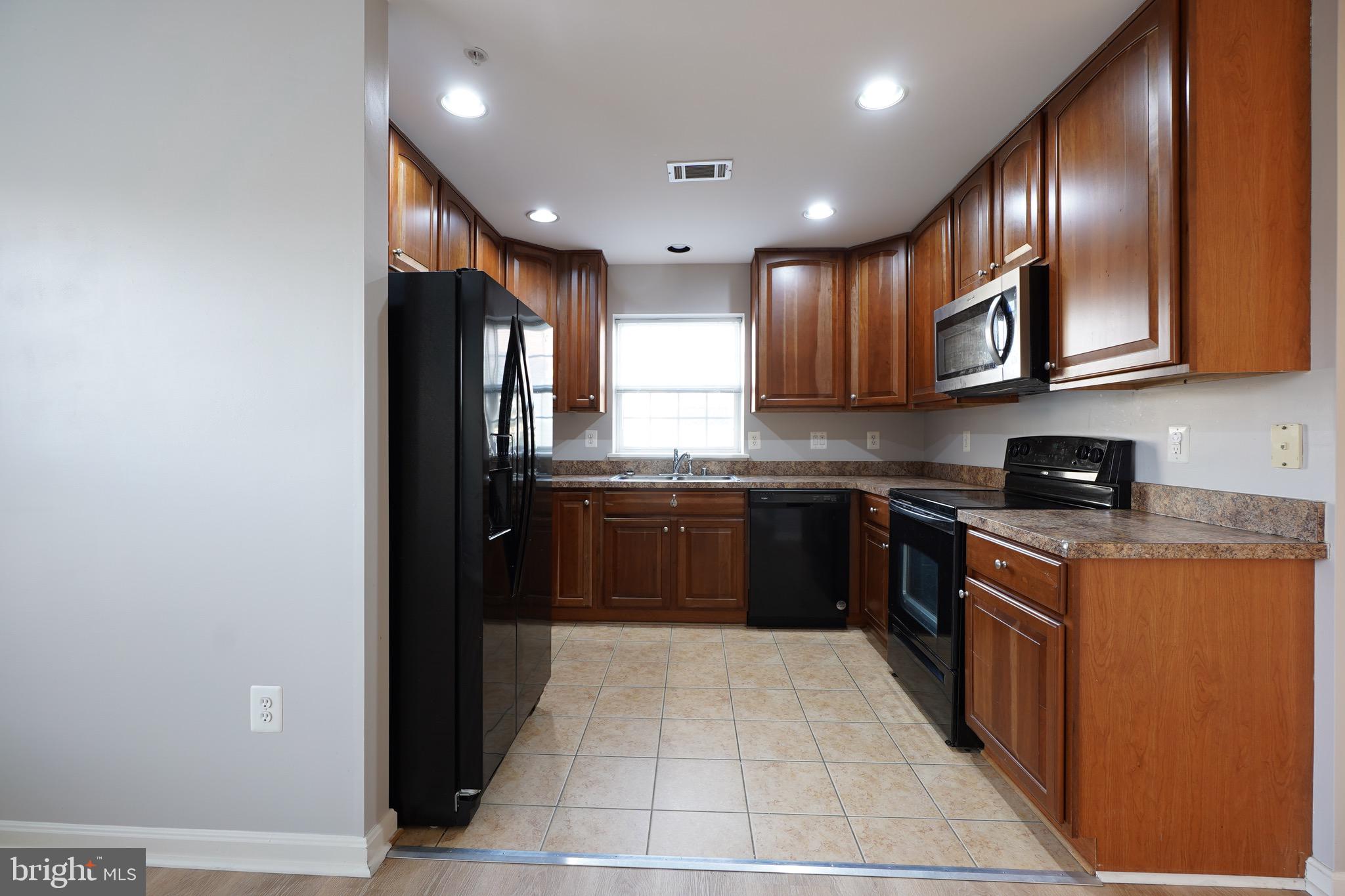 2502 Hemingway Drive, Unit 23B Frederick, MD 21702 - Photo 14 of 30 a kitchen with stainless steel appliances granite countertop a refrigerator and a stove top oven