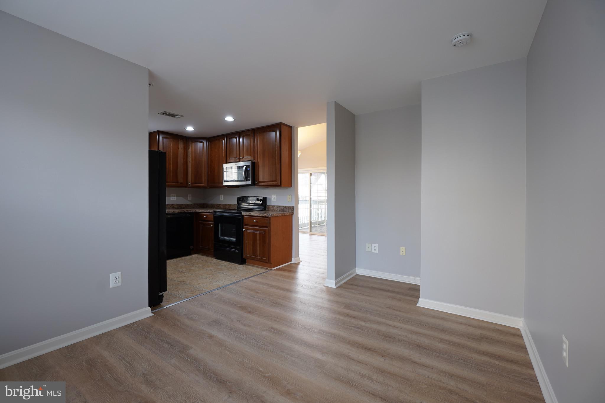 2502 Hemingway Drive, Unit 23B Frederick, MD 21702 - Photo 17 of 30 a view of kitchen with refrigerator and wooden floor