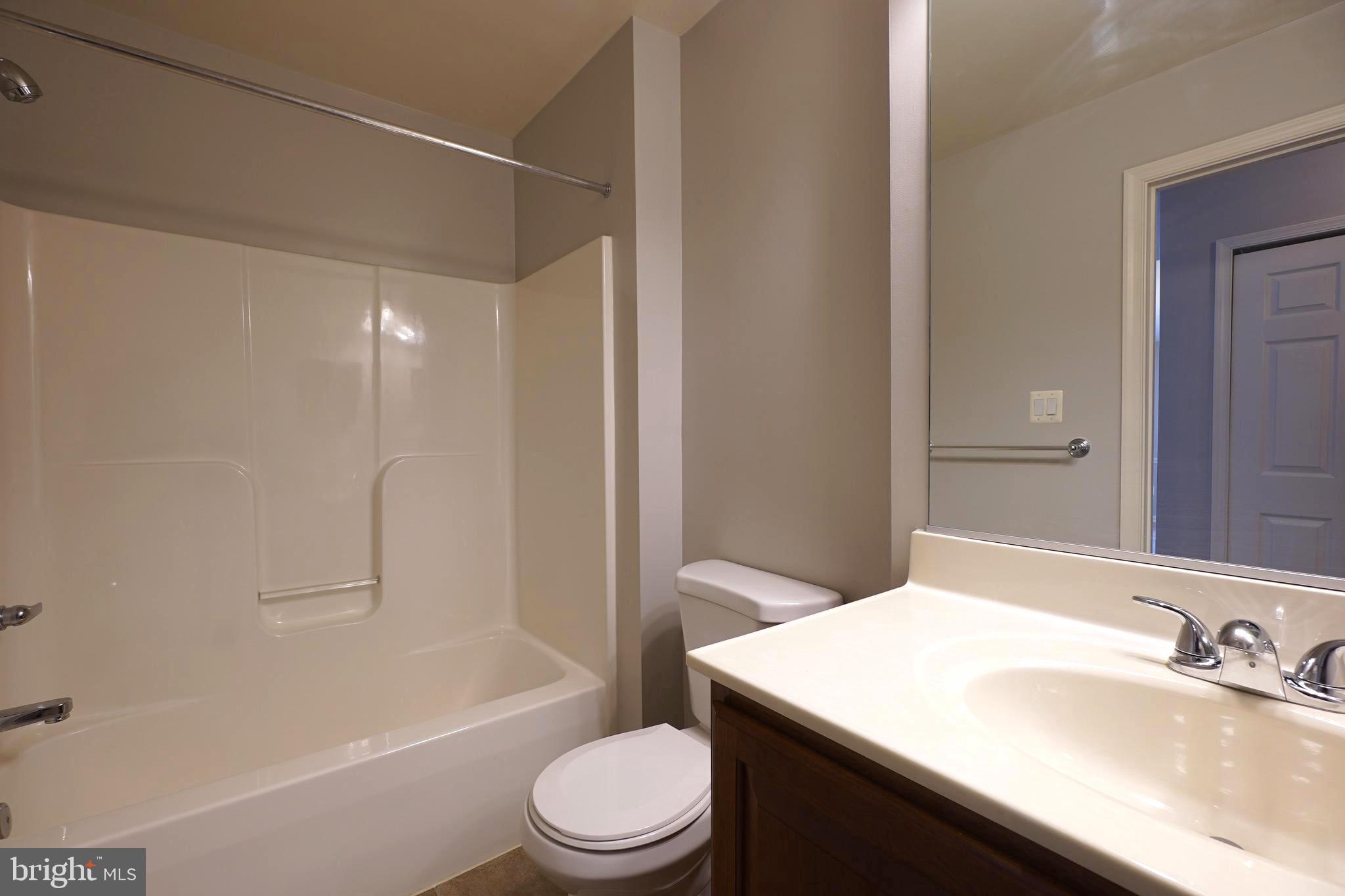 2502 Hemingway Drive, Unit 23B Frederick, MD 21702 - Photo 19 of 30 a bathroom with a sink a toilet and shower