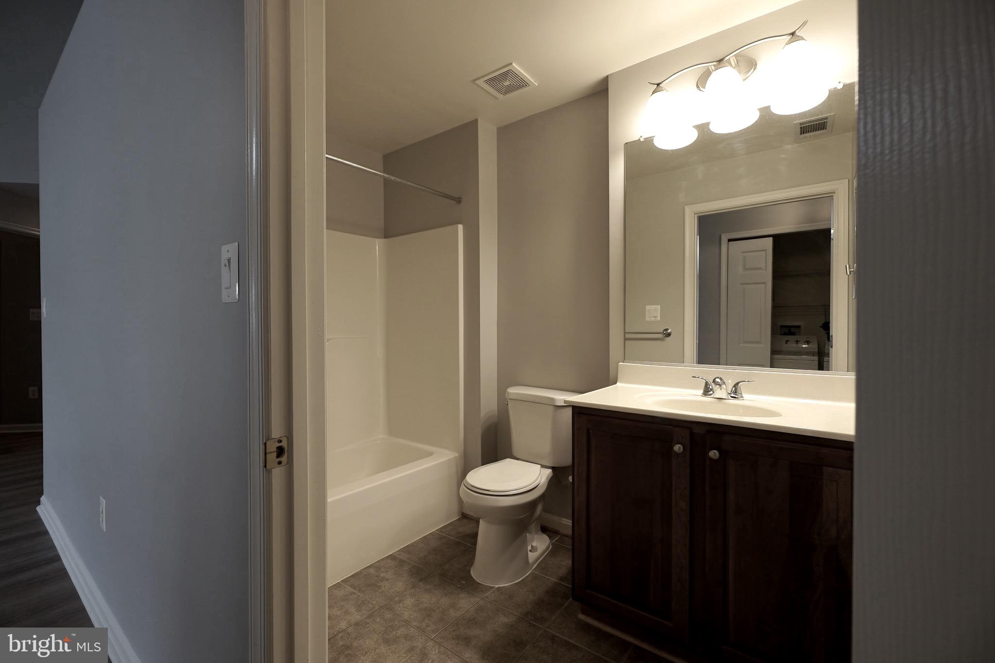 2502 Hemingway Drive, Unit 23B Frederick, MD 21702 - Photo 20 of 30 a bathroom with a sink a toilet and shower