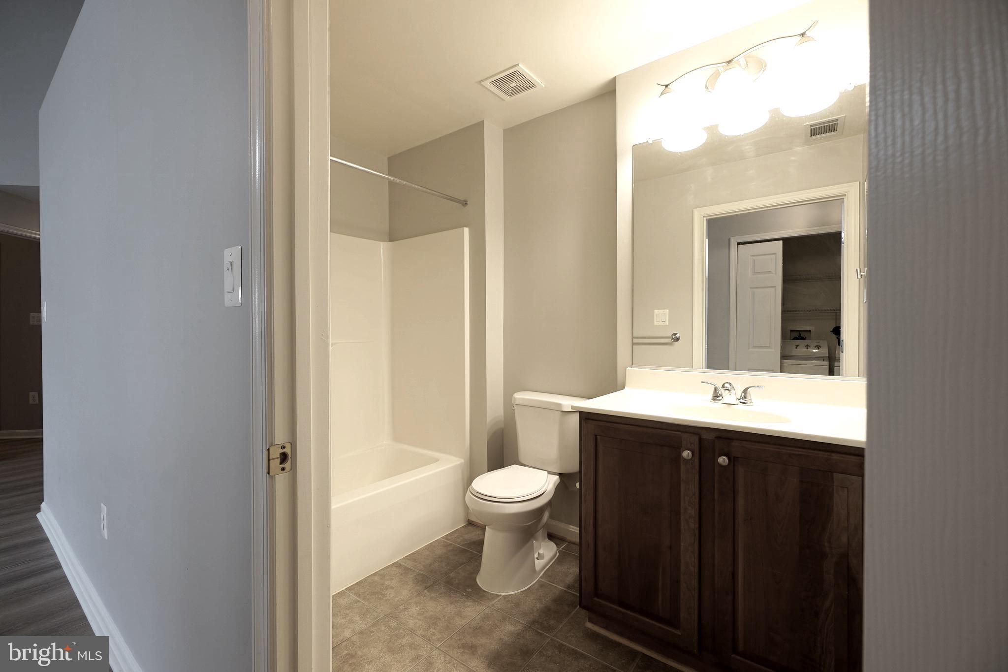 2502 Hemingway Drive, Unit 23B Frederick, MD 21702 - Photo 21 of 30 a bathroom with a granite countertop sink toilet and shower