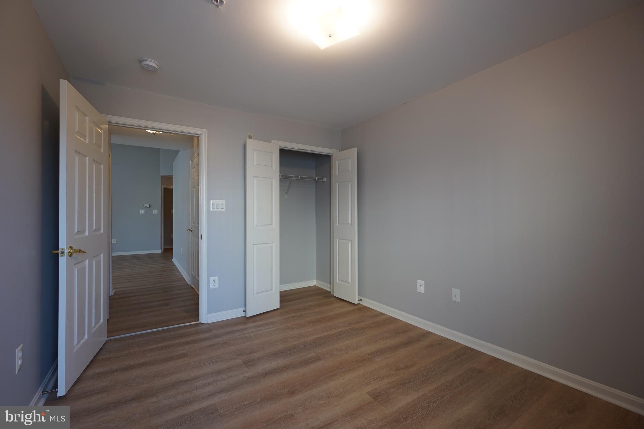2502 Hemingway Drive, Unit 23B Frederick, MD 21702 - Photo 23 of 30 a view of an empty room with wooden floor and closet