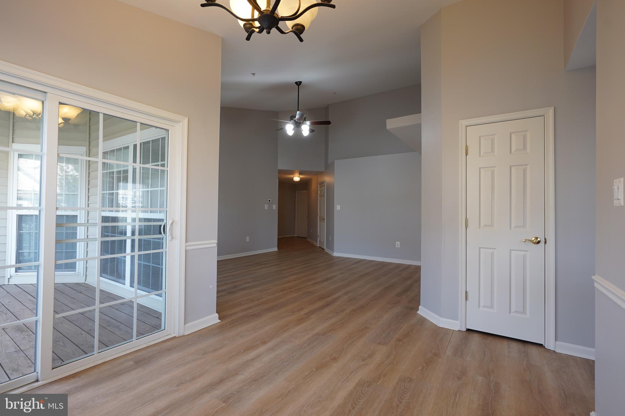 2502 Hemingway Drive, Unit 23B Frederick, MD 21702 - Photo 4 of 30 wooden floor in an empty room with a window