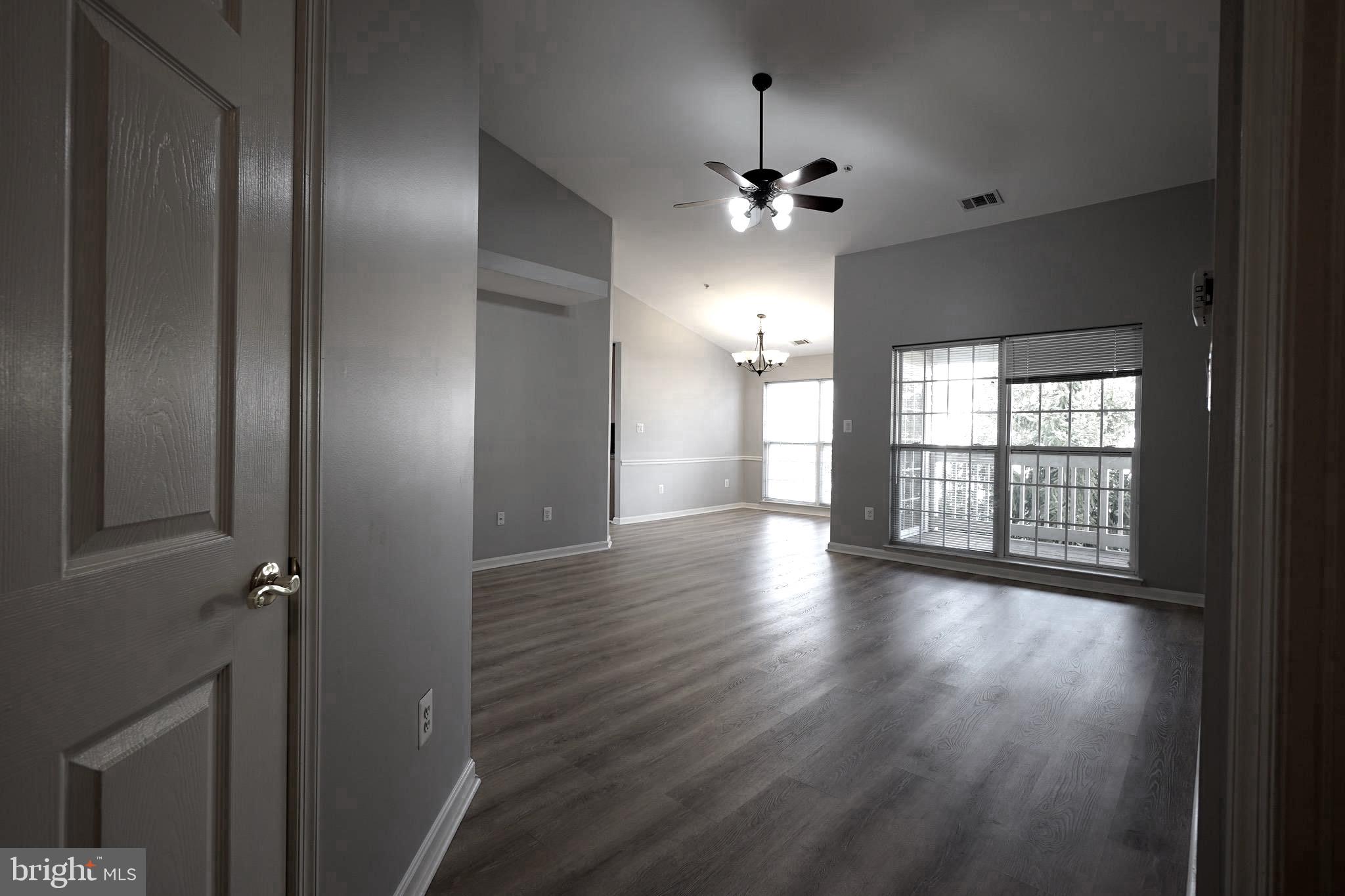 2502 Hemingway Drive, Unit 23B Frederick, MD 21702 - Photo 6 of 30 wooden floor in an empty room with a window