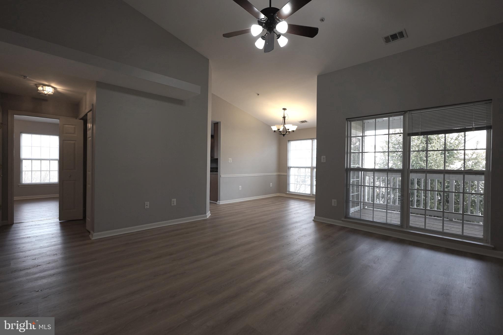 2502 Hemingway Drive, Unit 23B Frederick, MD 21702 - Photo 7 of 30 an empty room with wooden floor and windows