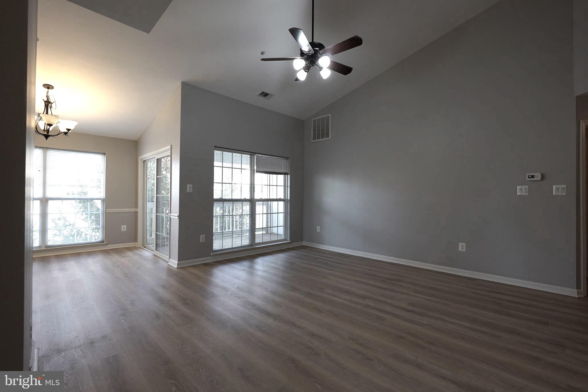 2502 Hemingway Drive, Unit 23B Frederick, MD 21702 - Photo 10 of 30 a view of an empty room with wooden floor and a window