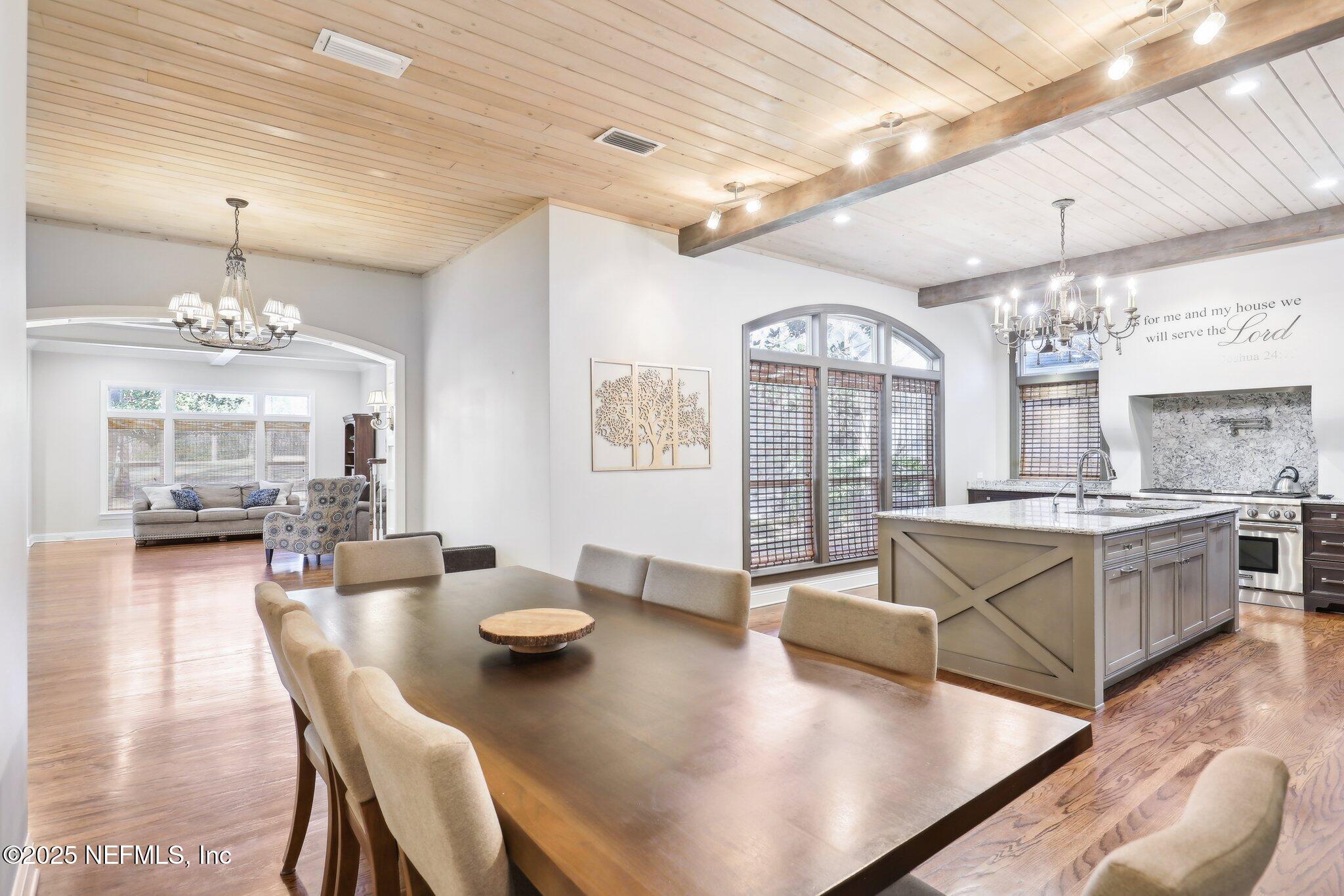 1836 Commodore Point Drive Fleming Island, FL 32003 - Photo 12 of 75 a large dining space with furniture a chandelier and wooden floor
