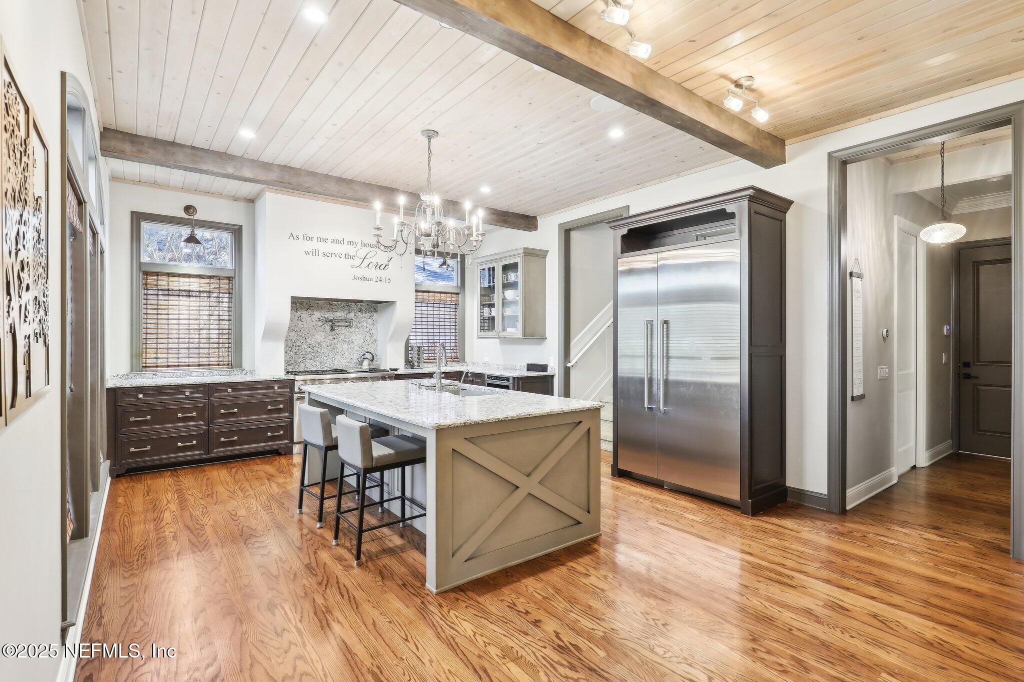 1836 Commodore Point Drive Fleming Island, FL 32003 - Photo 13 of 75 a kitchen with stainless steel appliances granite countertop a stove a refrigerator and a wooden floors