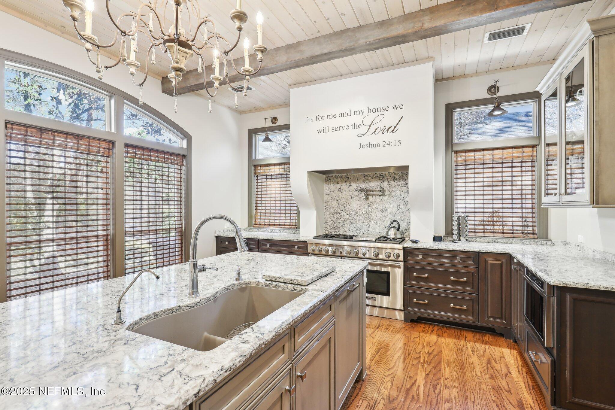 1836 Commodore Point Drive Fleming Island, FL 32003 - Photo 14 of 75 a kitchen with a stove a sink and cabinets