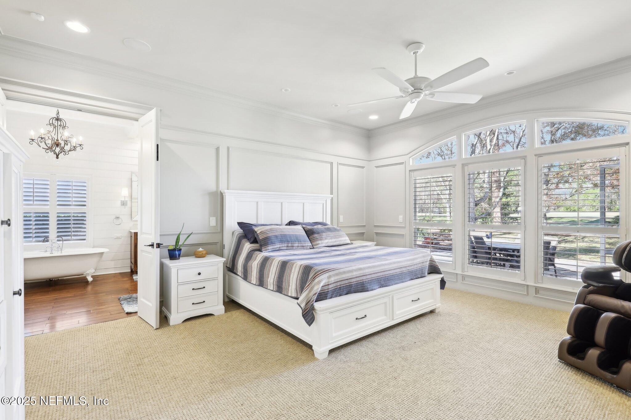 1836 Commodore Point Drive Fleming Island, FL 32003 - Photo 20 of 75 a spacious bedroom with a bed couch and large window