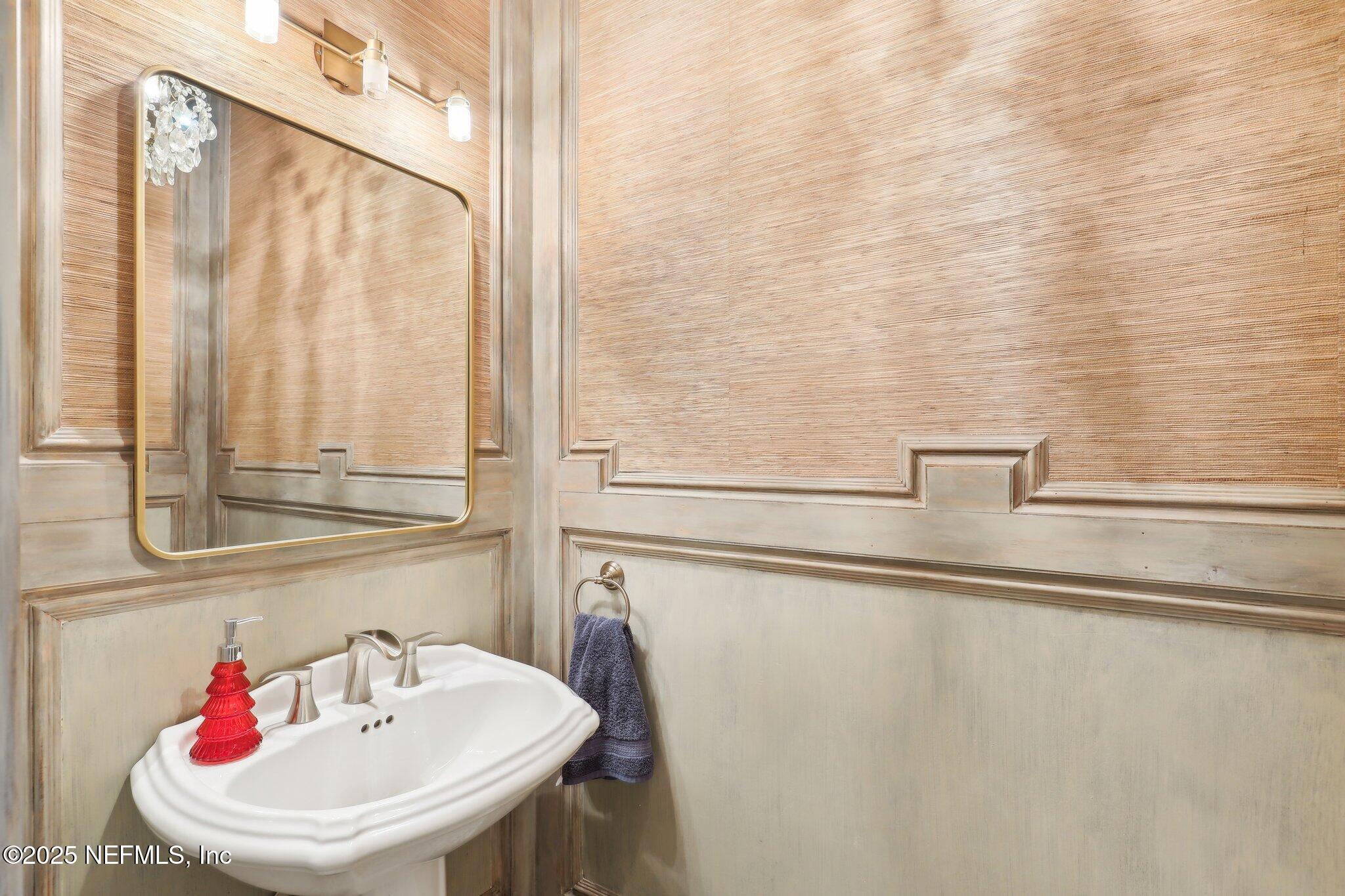 1836 Commodore Point Drive Fleming Island, FL 32003 - Photo 24 of 75 a bathroom with a sink and mirror with bathtub