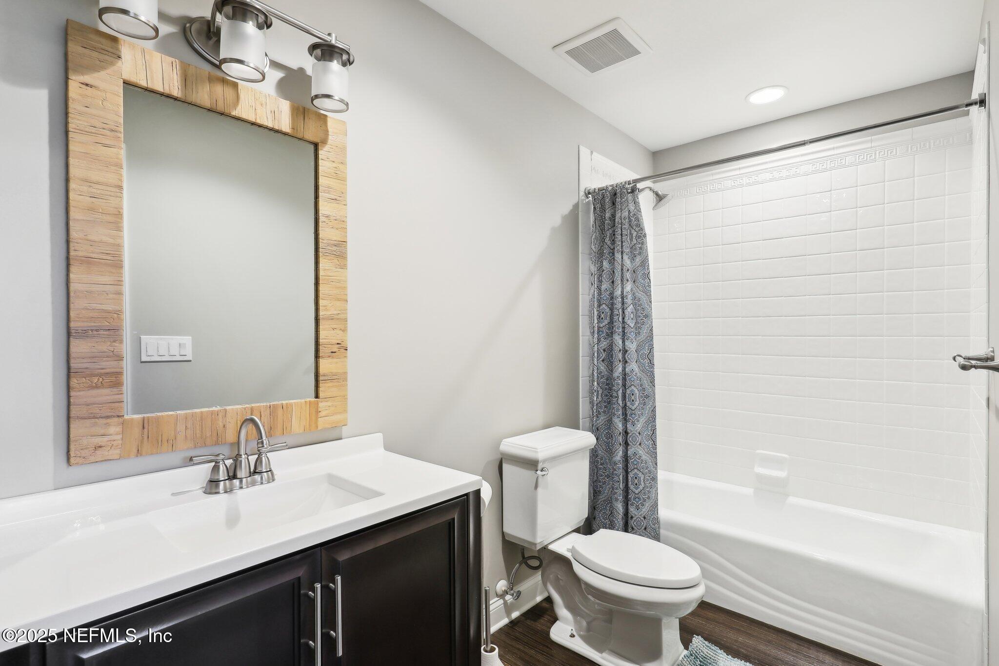 1836 Commodore Point Drive Fleming Island, FL 32003 - Photo 32 of 75 a bathroom with a sink a toilet and shower