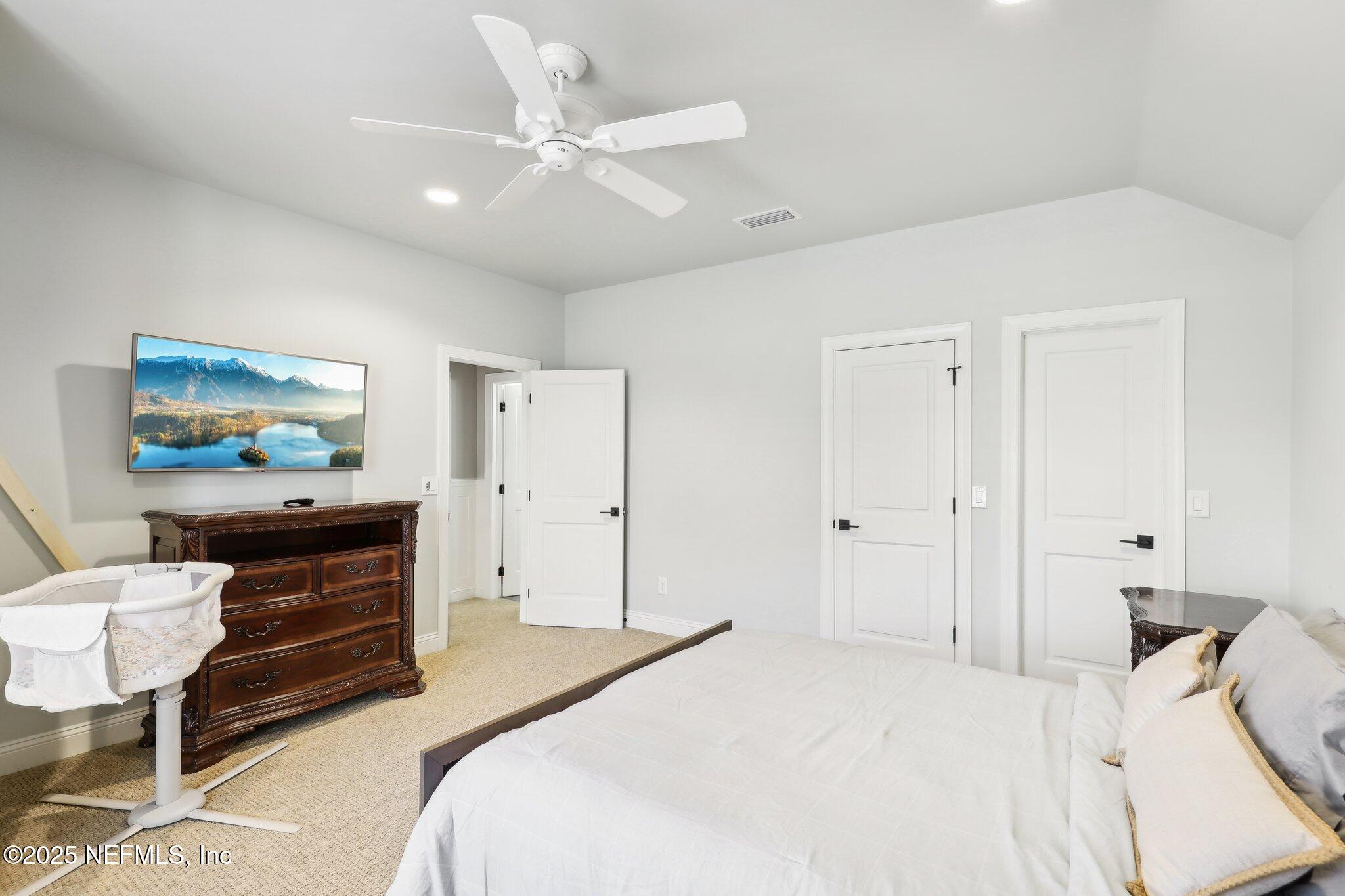 1836 Commodore Point Drive Fleming Island, FL 32003 - Photo 34 of 75 a bedroom with a bed and a flat screen tv