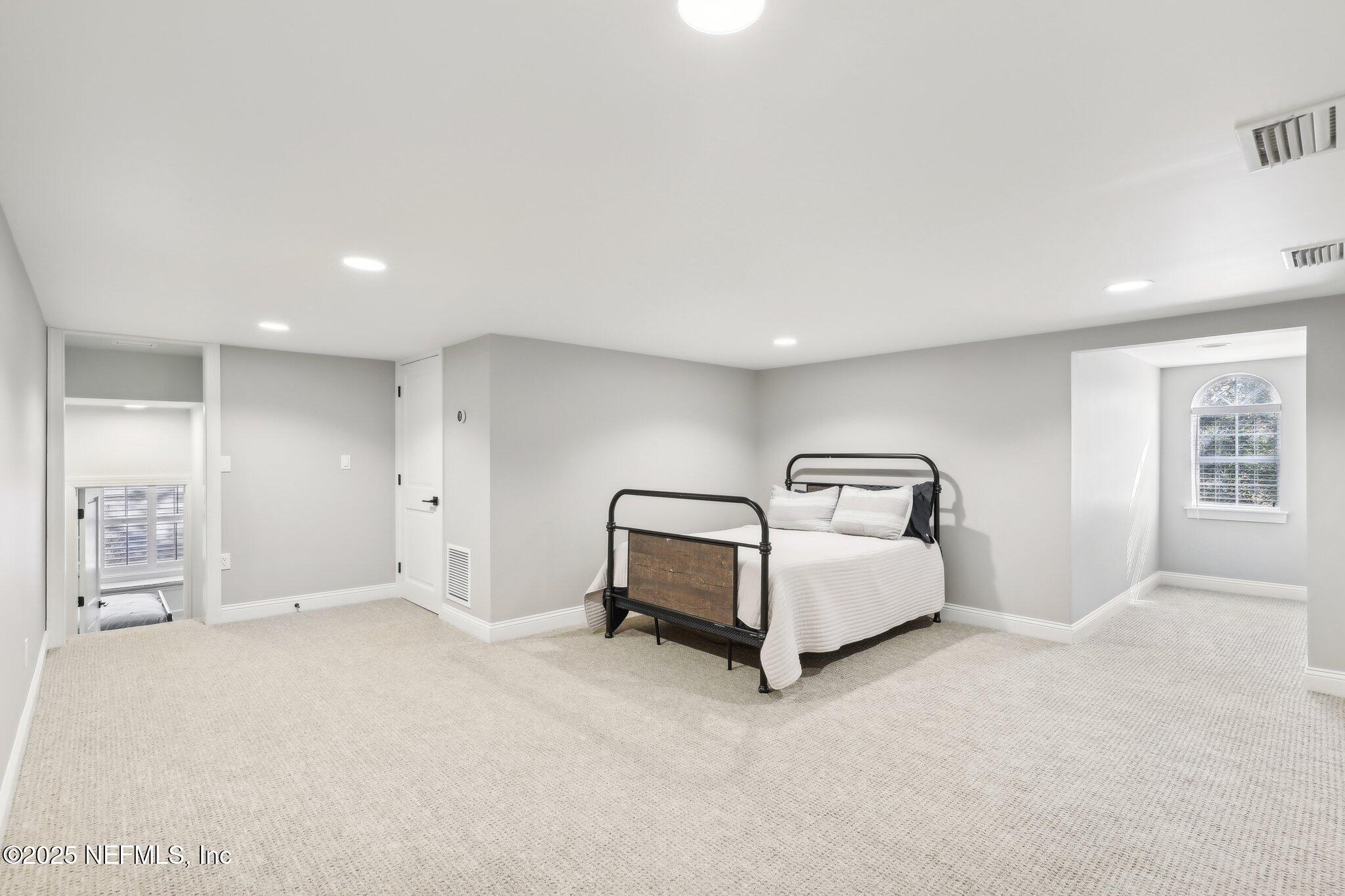 1836 Commodore Point Drive Fleming Island, FL 32003 - Photo 37 of 75 a spacious bedroom with a bed and a cabinets