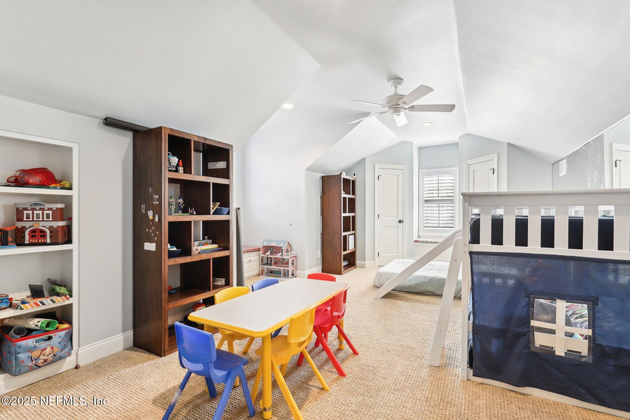 1836 Commodore Point Drive Fleming Island, FL 32003 - Photo 38 of 75 a living room with furniture a rug and a bookshelf