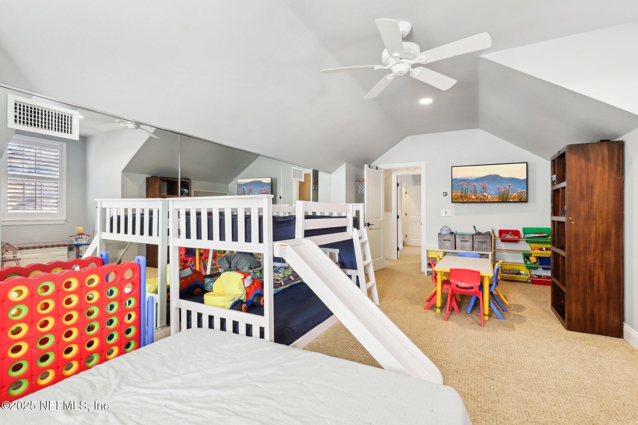 1836 Commodore Point Drive Fleming Island, FL 32003 - Photo 39 of 75 a bedroom with furniture a baby bed and a chandelier
