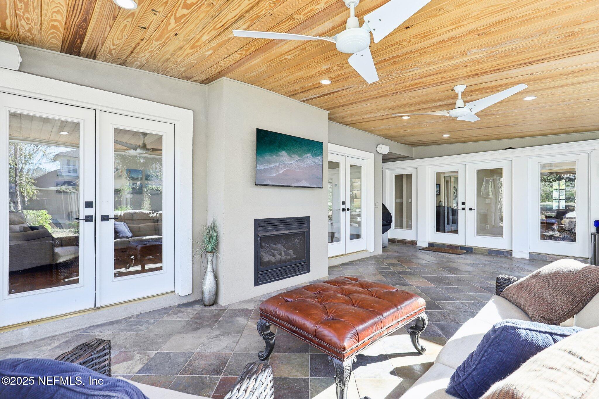 1836 Commodore Point Drive Fleming Island, FL 32003 - Photo 40 of 75 a living room with furniture a flat screen tv and a fireplace