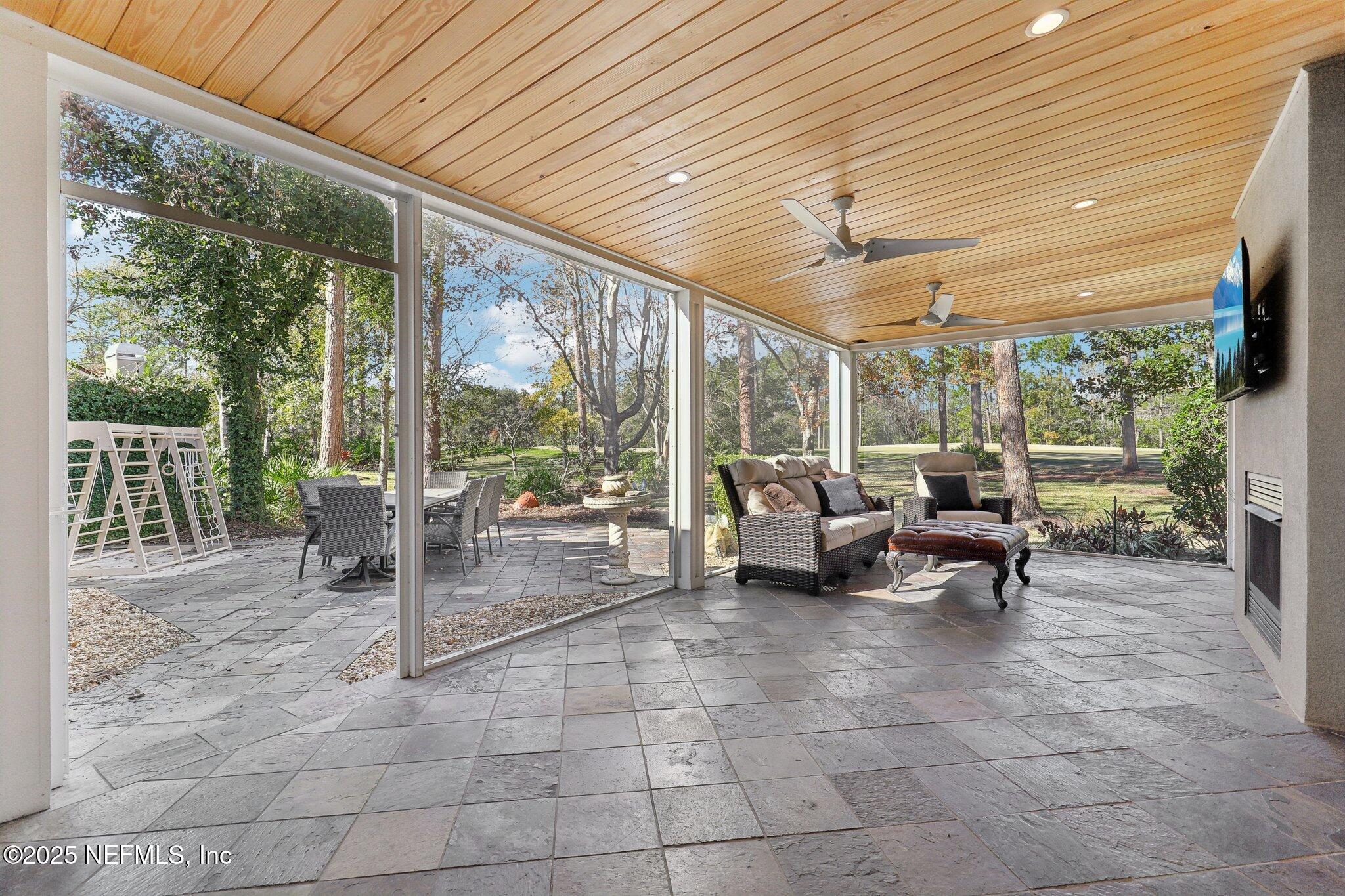 1836 Commodore Point Drive Fleming Island, FL 32003 - Photo 41 of 75 a view of a patio with table and chairs and wooden floor