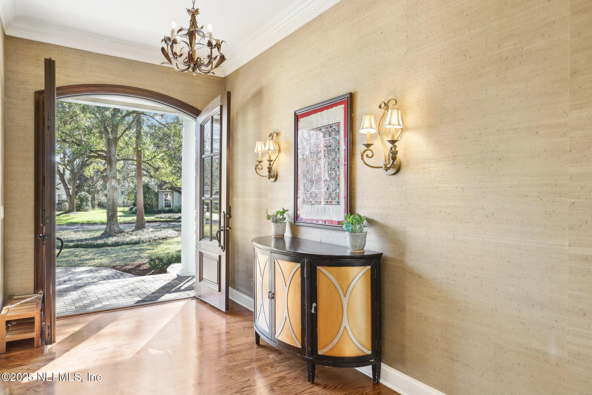 1836 Commodore Point Drive Fleming Island, FL 32003 - Photo 5 of 75 a view of a hallway with wooden floor and windows
