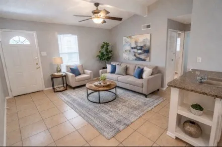 a living room with furniture and a chandelier