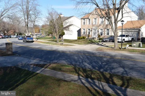a view of a yard with yellow house