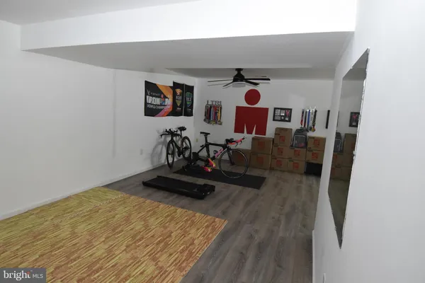 a view of a kitchen with fridge and wooden floor