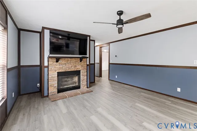 a living room with a fireplace and a flat screen tv