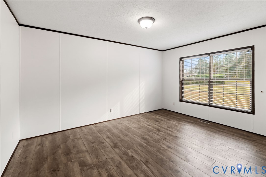 11391 Watkins Road Rockville, VA 23146 - Photo 16 of 28 a view of an empty room with a window and hardwood floor