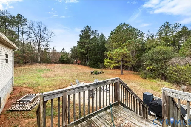 a view of a balcony with wooden floor and fence