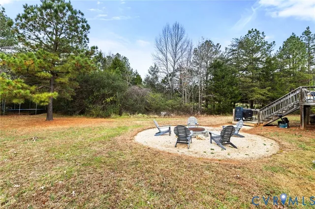 a view of backyard with swimming pool and seating space