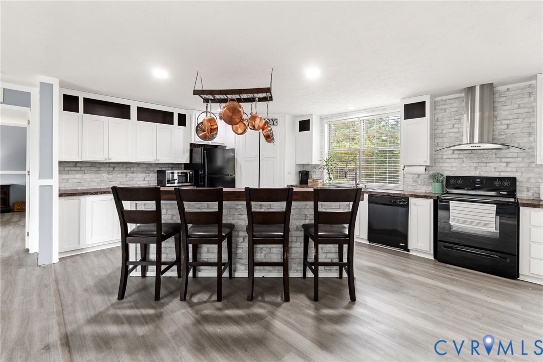11391 Watkins Road Rockville, VA 23146 - Photo 5 of 28 a kitchen with stainless steel appliances granite countertop a stove a sink and a refrigerator