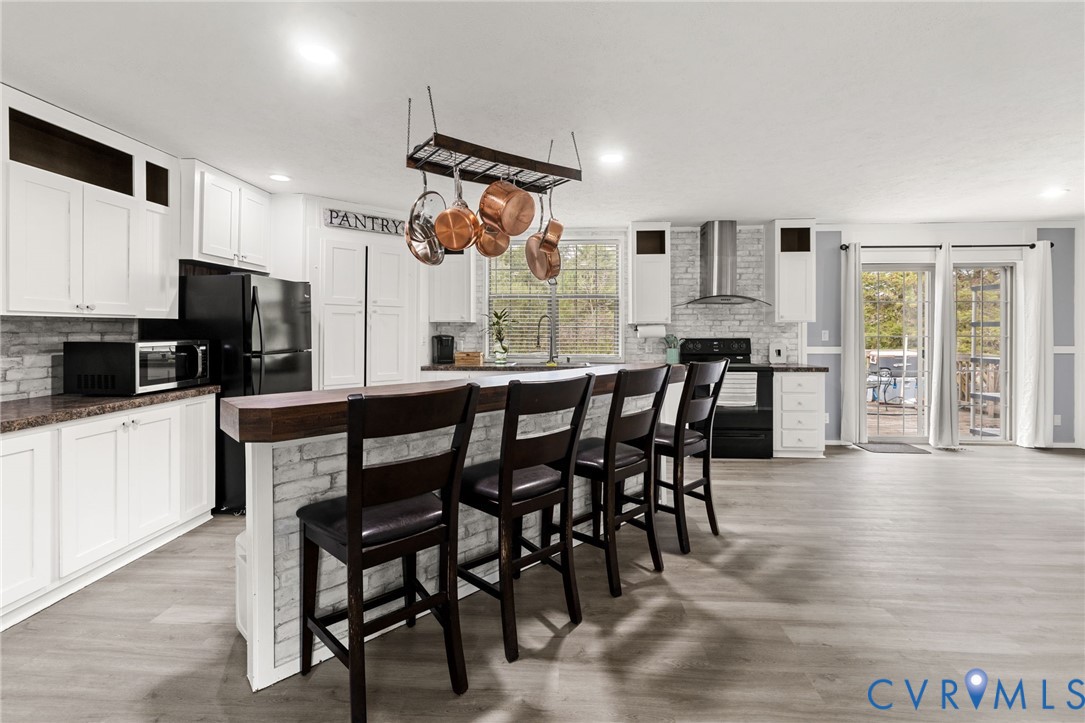 11391 Watkins Road Rockville, VA 23146 - Photo 6 of 28 a kitchen with stainless steel appliances kitchen island granite countertop a dining table chairs and granite counter tops