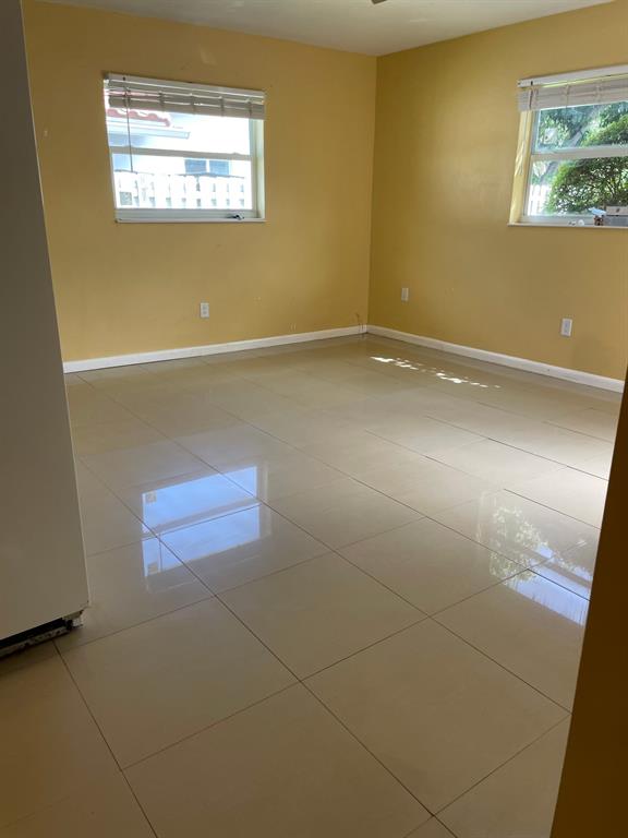 1911 Northeast 28th Street, Unit 4 Lighthouse Point, FL 33064 - Photo 4 of 9 an empty room with windows