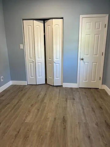 an empty room with windows and closet