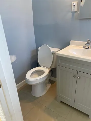 a white toilet sitting next to a bathroom sink