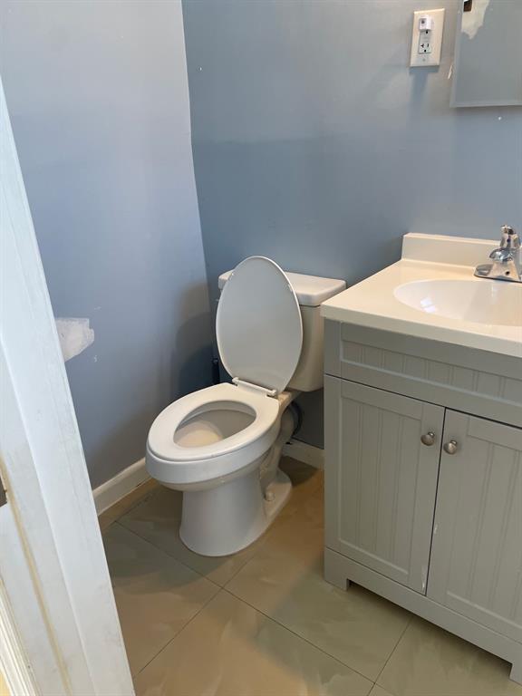 1911 Northeast 28th Street, Unit 4 Lighthouse Point, FL 33064 - Photo 8 of 9 a white toilet sitting next to a bathroom sink