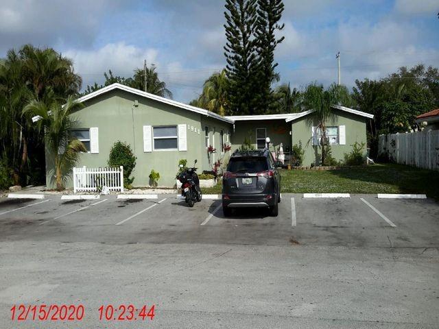 1911 Northeast 28th Street, Unit 4 Lighthouse Point, FL 33064 - Photo 9 of 9 a view of a car parked in front of a house