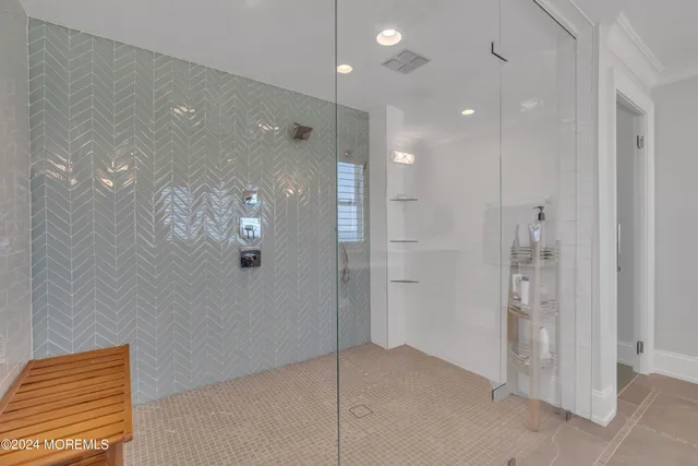 a bathroom with a shower sink and mirror