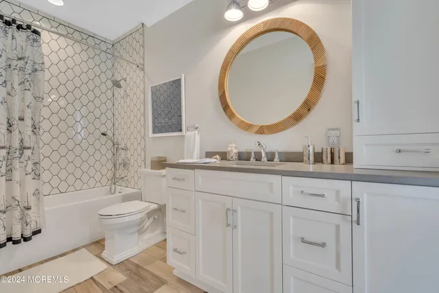 a view of a hallway with wooden floor and entryway