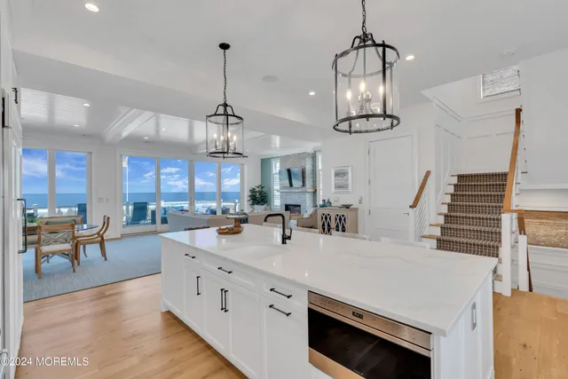a very nice looking kitchen with a large window table and chairs