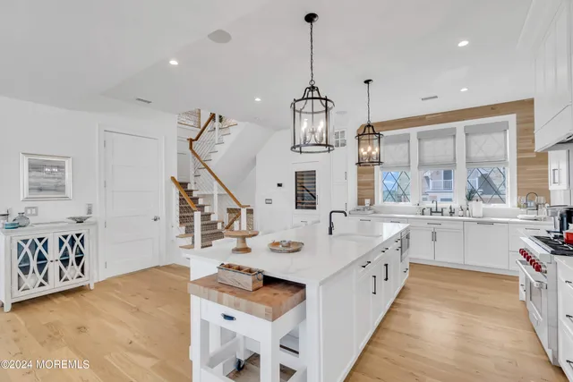 a kitchen with sink stove and refrigerator