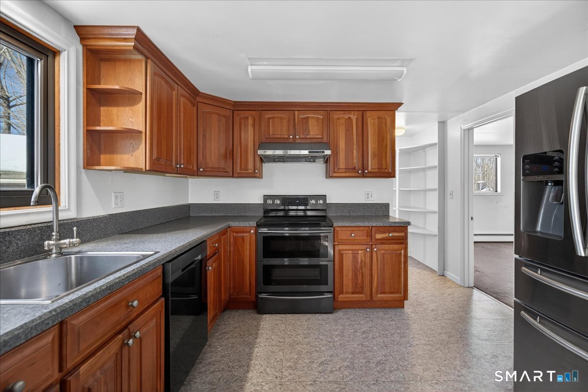 18 Deer Path Lane North Branford, CT 06471 - Photo 11 of 33 a kitchen with stainless steel appliances granite countertop a stove and a refrigerator