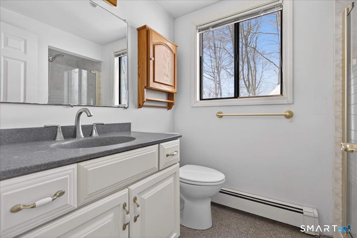 18 Deer Path Lane North Branford, CT 06471 - Photo 13 of 33 a bathroom with a granite countertop toilet sink and mirror