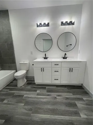 a bathroom with a toilet a sink and a mirror