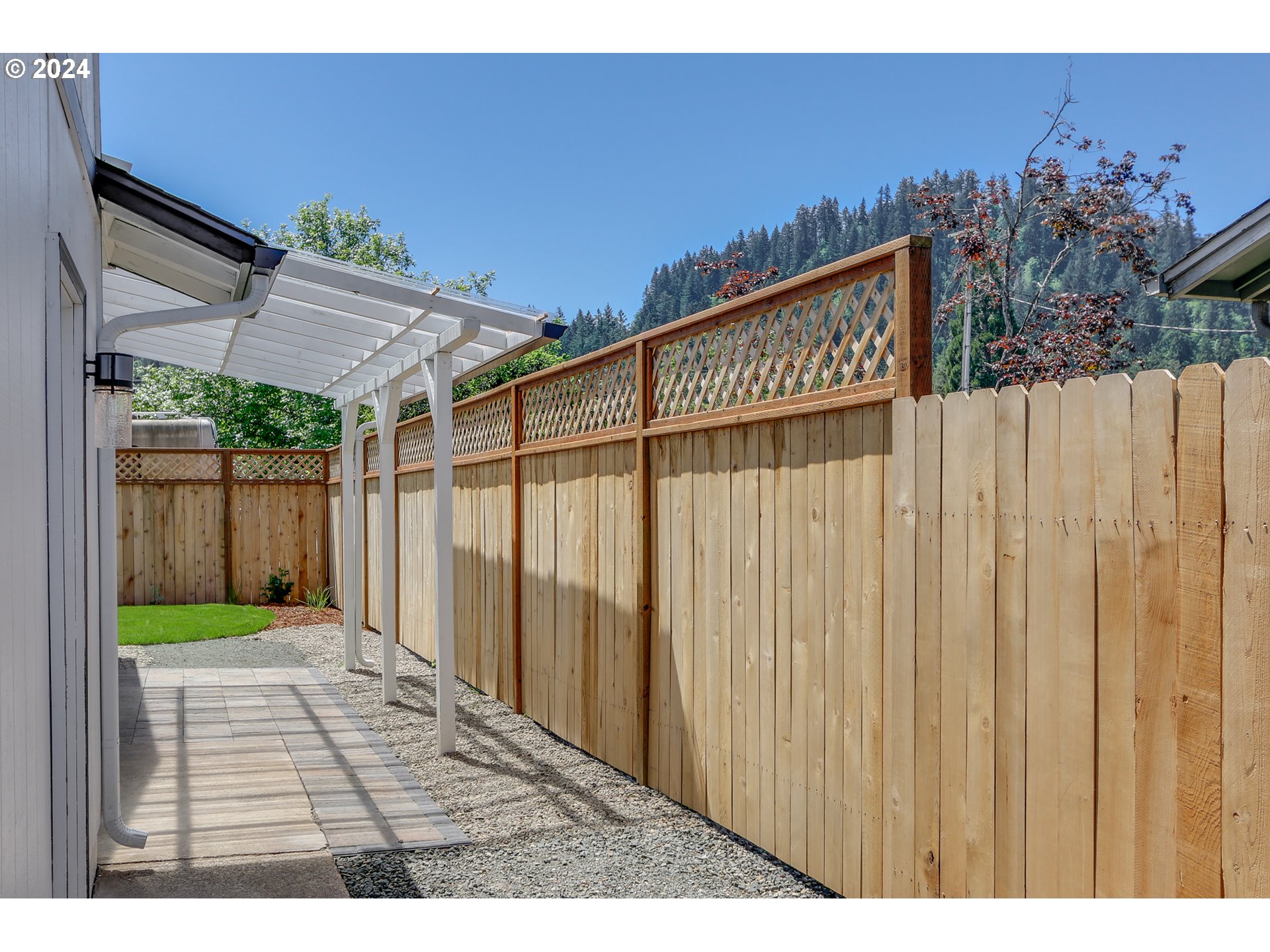 6757 A Street Springfield, OR 97478 - Photo 22 of 25 a view of a backyard with a wooden fence