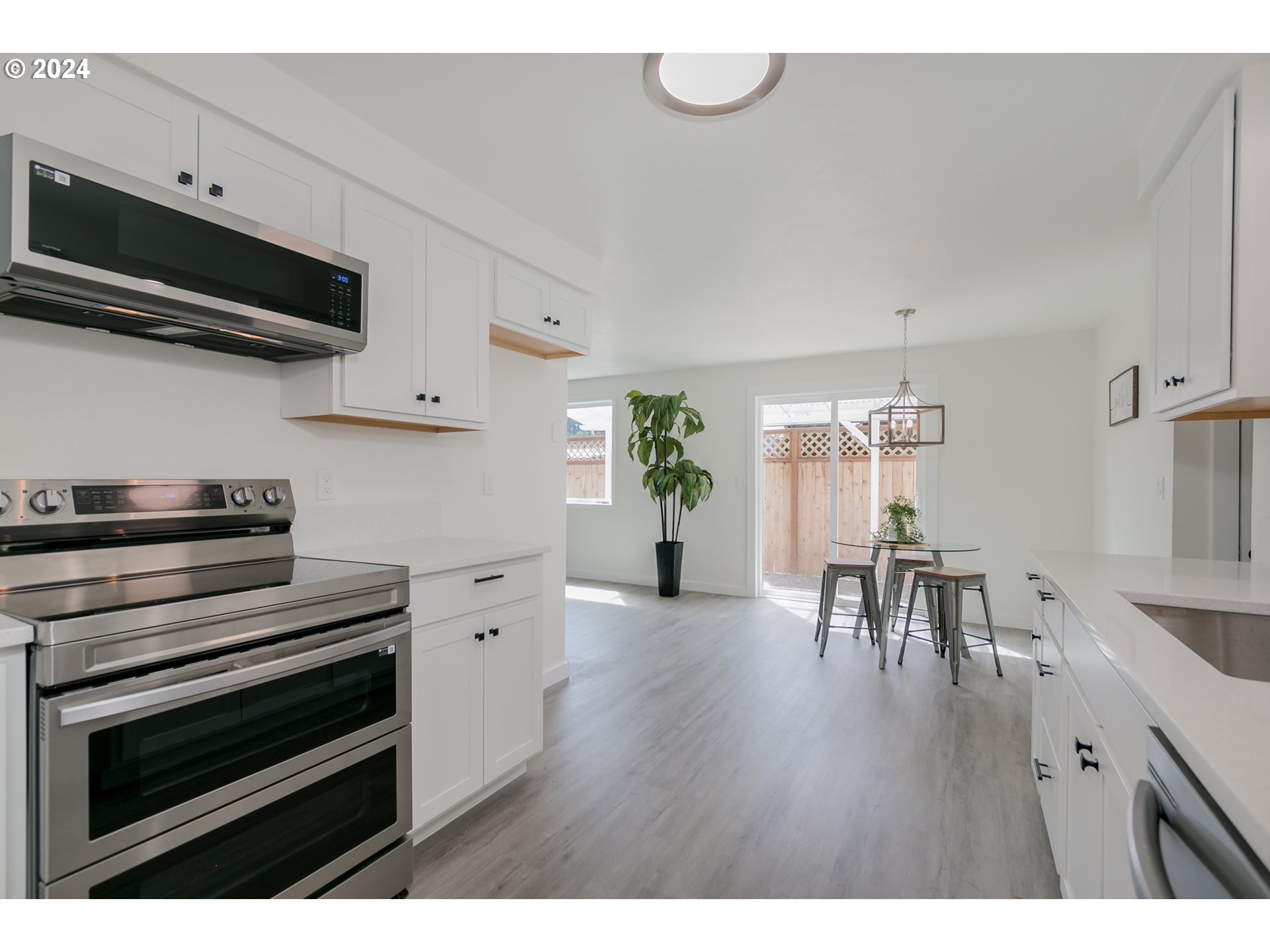 6757 A Street Springfield, OR 97478 - Photo 5 of 25 a kitchen with a table and chairs