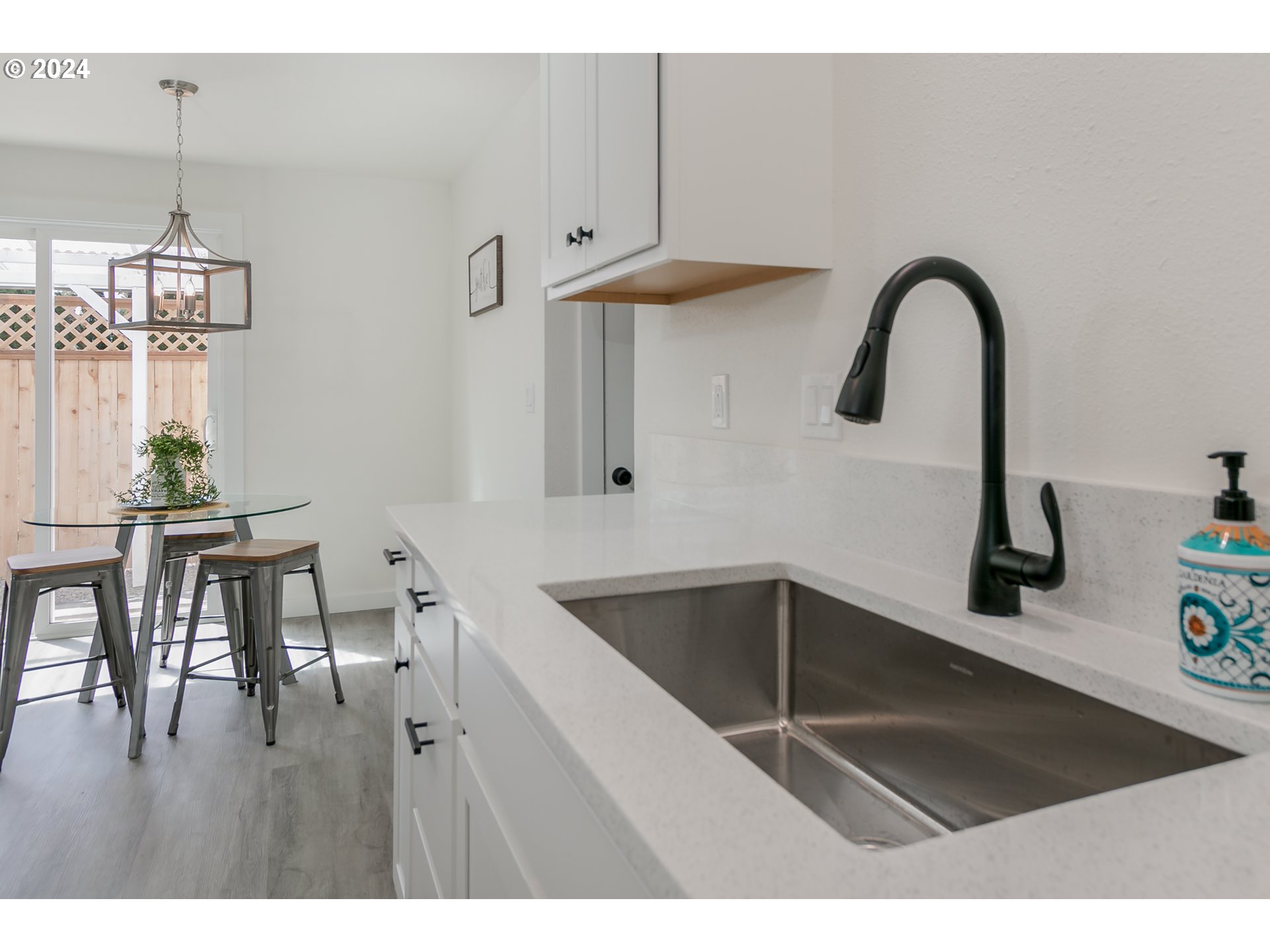 6757 A Street Springfield, OR 97478 - Photo 6 of 25 a kitchen with a refrigerator and a table