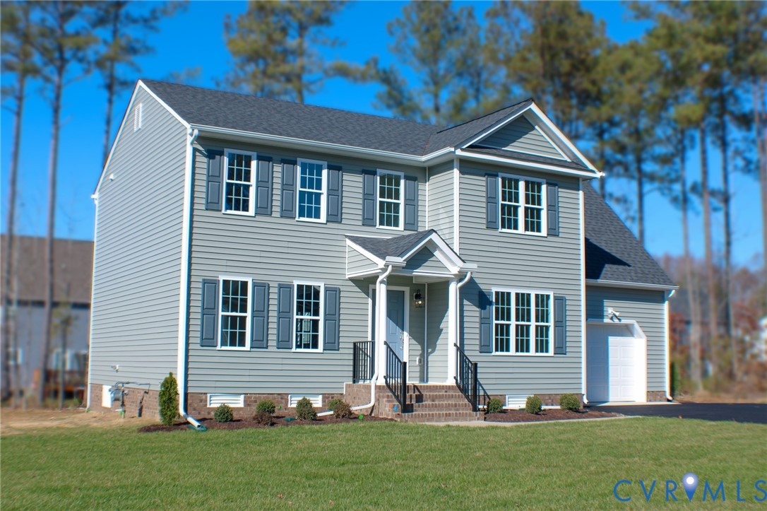 8249 Reedy Knl Drive Richmond, VA 23237 - Photo 2 of 11 a front view of a house with a yard